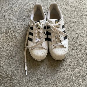 Black and white Adidas superstars